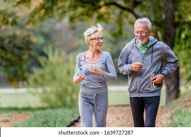 Cheerful active senior couple exercising in the park together. Exercise to stop aging. - Powered by Shutterstock