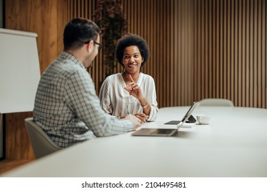 Cheerful adult diverse coworkers, working in a new big office together. - Shutterstock ID 2104495481