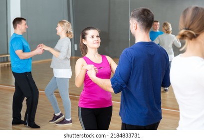 Cheerful Adults Learning To Dance Kizomba With Partners In Dancing Group Class