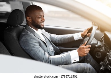 Cheerful African American Businessman Driving To Work, Shot Through Window, Side View