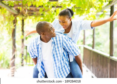 Cheerful African American Couple Piggyback Outdoors