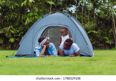 Cheerful african american family enjoying in the park, Happiness family concepts - Powered by Shutterstock