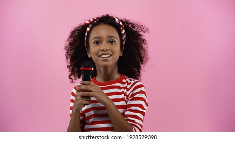 Cheerful African American Girl Holding Microphone Isolated On Pink