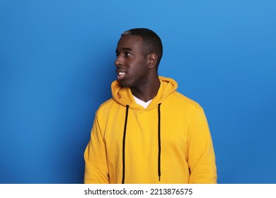 Cheerful African American Guy Smiling Over Blue Background. Studio Shot Of Happy Self-Confident Black Millennial Man Expressing Positive Emotions