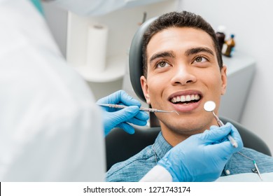  cheerful african american man with during examination in dental clinic 