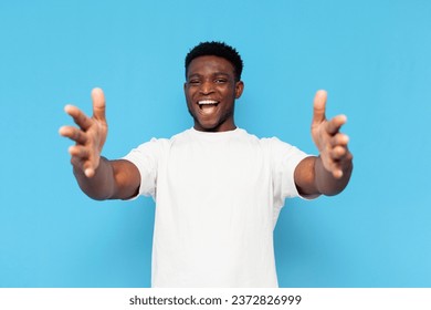 cheerful african american man in white t-shirt stretches his arms forward and shows hug, the man hugs and holds empty hands in front of him - Powered by Shutterstock