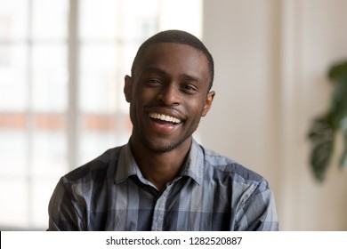Cheerful african american millennial man with happy face looking at camera at home, head shot of smiling young black single guy laughing posing indoors, confident charming male person portrait - Shutterstock ID 1282520887