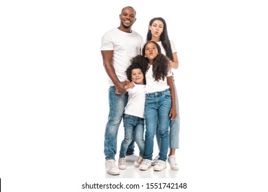 cheerful african american mother and daughter making duck faces while standing near father and son on white background