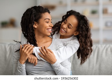 Cheerful african american mother and daughter having fun at home - Shutterstock ID 1936256302