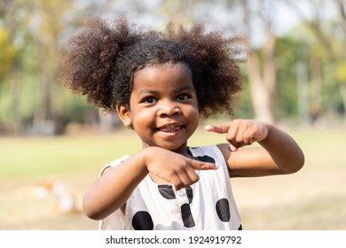 Cheerful African American Toddler Little Girl Playing Outdoor In The Park. Cute Black People Child Girl With Hair Curly Laughing Outdoor