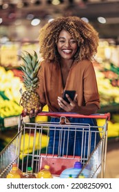 Cheerful African American Woman In Supermarket Choosing Fresh Fruits  - Shutterstock ID 2208250901