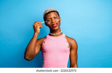 Cheerful African Androgynous Person Applying Makeup In Studio