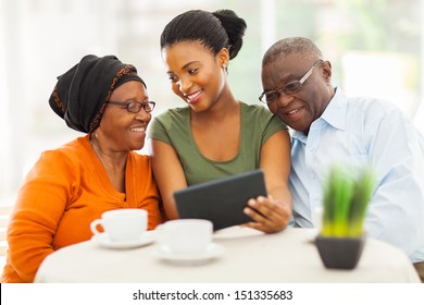 cheerful african family at home using tablet pc - Powered by Shutterstock