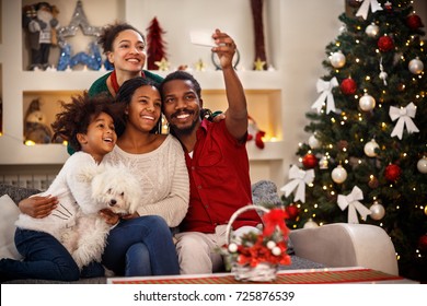 Cheerful African family making selfie together for Christmas - Shutterstock ID 725876539