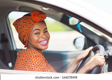 Cheerful African Female Driver Inside A Car