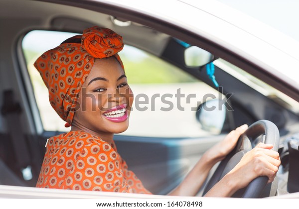 cheerful african
female driver inside a
car
