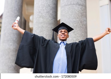 Cheerful African Male Graduate Holding His Diploma