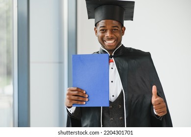 Cheerful African Male Graduate Holding His Diploma