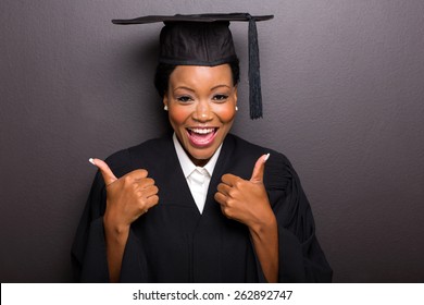 Cheerful Afro American Female College Graduate Thumbs Up