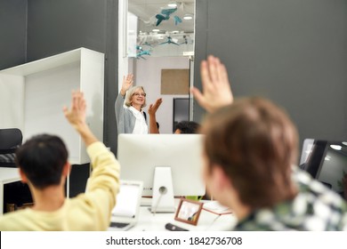 Cheerful Aged Woman, Senior Intern Waving, Saying Goodbye To Her Young Colleagues While Leaving Office After First Day At Work, Selective Focus, Horizontal Shot