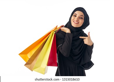 Cheerful Arab Woman In A Black Burqa With Shopping Bags In Her Hands