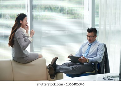 Cheerful Asian business people working in office - Shutterstock ID 1066405346