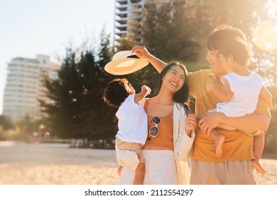 Cheerful Asian Family Travel At The Beach.cute Asian Boy Playing With Parents.