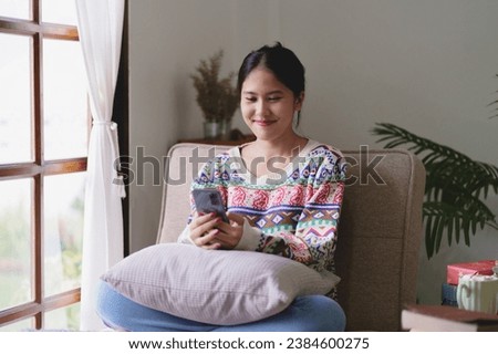 Cheerful asian girl using phone in Christmas event celebrate, Happy Holidays.
