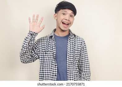 Cheerful Asian Man Waving To Say Hello On Isolated Background