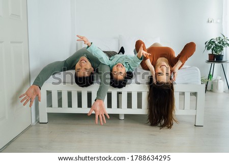 Similar – Image, Stock Photo Relaxed mother and sons playing over the bed