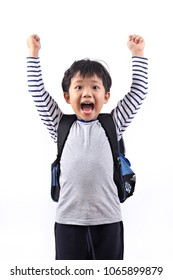 A Cheerful Asian Primary School Boy Rising Hands With Excited Expression Isolated On White Background.