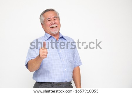 Cheerful Asian senior man giving a thumb up and looking at the camera isolated on white background