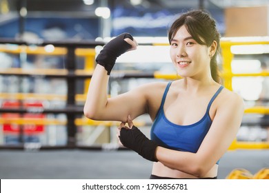 Cheerful Asian Woman Catching On Her Fat Arm With Copyspace. Young Fat Woman Trying To Exercise For Better Health. Cardio Workout And Muscle Training. Confident Sportswoman Pose For Photography.