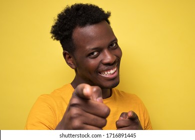 Cheerful attractive african man pointing on you making a choice. You are my bro. Stuio shot. Close up view - Shutterstock ID 1716891445