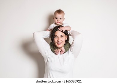 A Cheerful Baby Boy Toddler With His Mother On White Studio Background