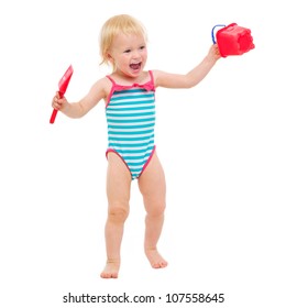 Cheerful Baby Girl In Swimsuit With Bucket And Shovel