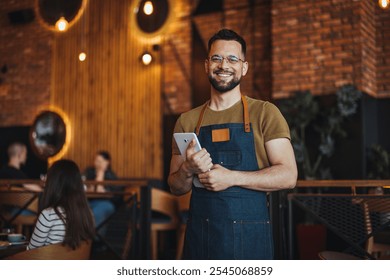 A cheerful barista stands confidently in a stylish cafe, holding a tablet. The atmosphere is warm and inviting, with rustic decor and patrons enjoying their time in the background. - Powered by Shutterstock