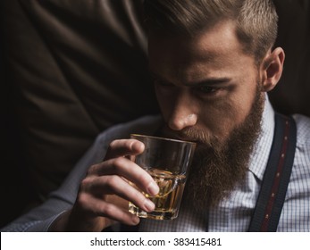 Cheerful Bearded Businessman Is Drinking Expensive Whisky