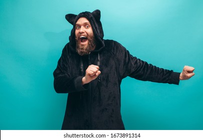 Cheerful Bearded Man In Black Cat Kigurumi Pajama. Crazy Emotions. Pajamas Party