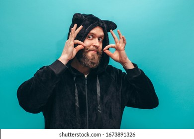 Cheerful Bearded Man In Black Cat Kigurumi Pajama. Crazy Emotions. Pajamas Party