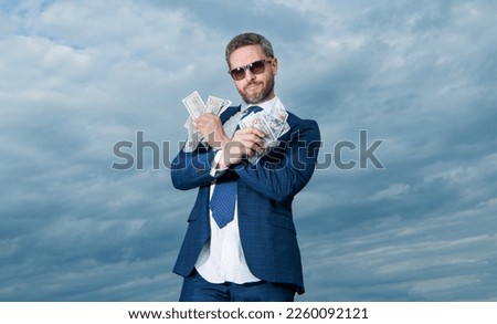 cheerful billionaire man with money in suit. photo of billionaire man with money.