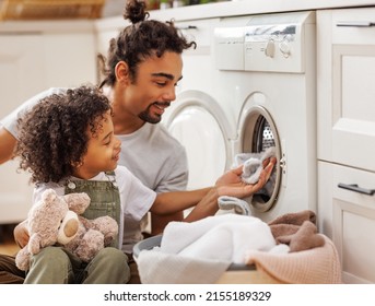 Cheerful Black Family: Kid Son Helping Father At Linen In Basket While Doing Laundry Near Washing Machine In Flight Kitchen In Weekend At Home  