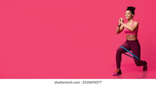 Cheerful black fitness girl making working out with resistance band over red studio background - Powered by Shutterstock