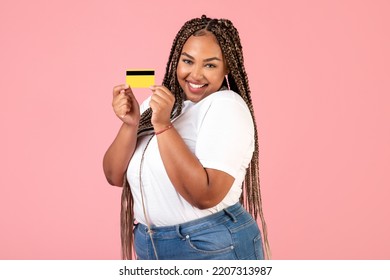 Cheerful Black Lady Showing Credit Card Recommending Bank Service Standing In Studio Over Pink Background, Smiling To Camera. Finances And Payments Concept - Powered by Shutterstock