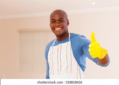 Cheerful Black Man Giving Thumb Up After Doing Housework