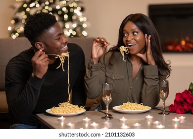 Cheerful Black Spouses Eating Pasta Celebrating St Valentine's Day Enjoying Romantic Dinner Together Sitting At Table Smiling Each Other At Home. Dating Romance And Valentine Holiday Celebration