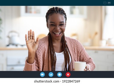 Cheerful Black Woman Having Video Conference, Making Web Call While Drinking Coffee In Kitchen, African Lady Waving Hand At Camera, Greeting Somebody, Enjoying Online Communication, Screenshot View - Shutterstock ID 1922847269