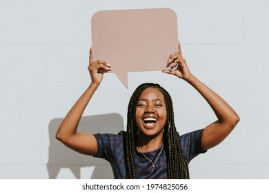 Cheerful black woman showing a blank speech bubble