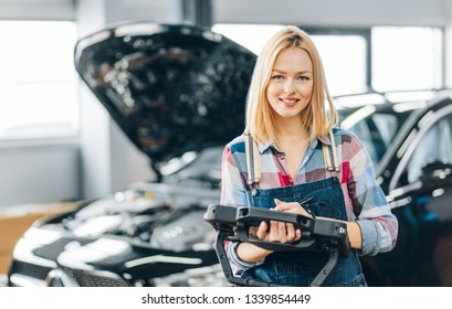 cheerful blond girl is ready to help you with your car problems. close up photo - Powered by Shutterstock