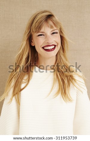 Cheerful blond woman smiling at camera